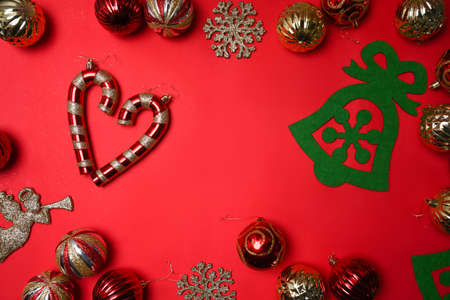 Red and gold Christmas baubles decoration on red background. Christmas holiday celebration concept.の写真素材