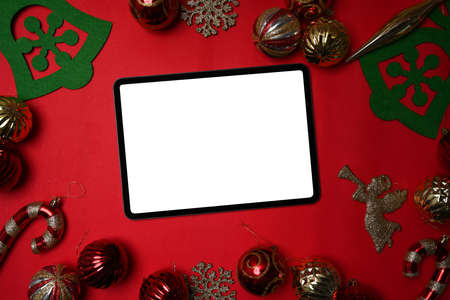 Christmas holiday celebration concept. Digital with Christmas decorations on white and red background.の写真素材