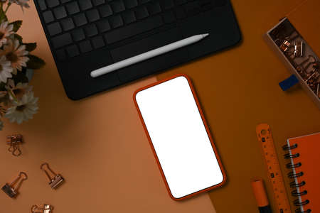 Above view smart phone with blank screen on brown leather.