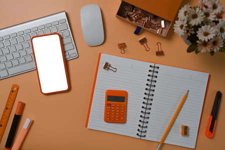 Top view mock up smart phone with blank display on brown background.の写真素材