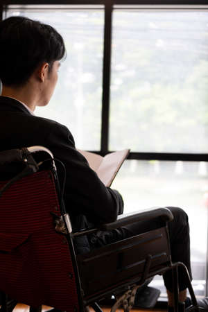 Businessman with disability working in office room.の写真素材