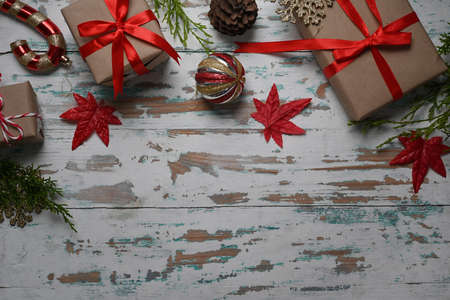 Teddy bear, Christmas gifts and cup of hot coffee on fir tree branches on wooden table. Christmas...