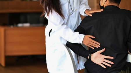Beautiful woman physiotherapist doing therapeutic exercises for her patient.の写真素材
