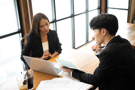 Two businesspeople discussing information on digital tablet together.の写真素材