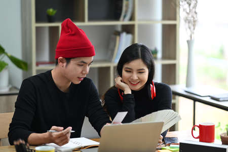 Team of creative designer choosing colors from palette guide for their new project.の写真素材