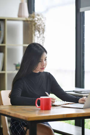 Attractive creative woman working in modern workplace.の写真素材