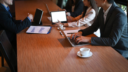 Confident businessman analyzing financial data with his business partner in office.の写真素材