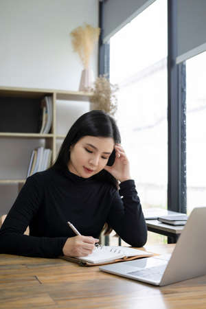 Attractive creative woman working in modern workplace.