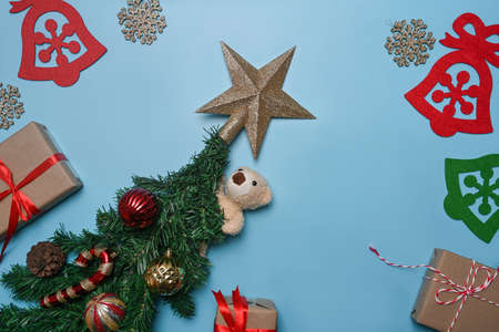 Santa hat, Christmas gifts, pine cone and fir tree branches on blue background.の写真素材