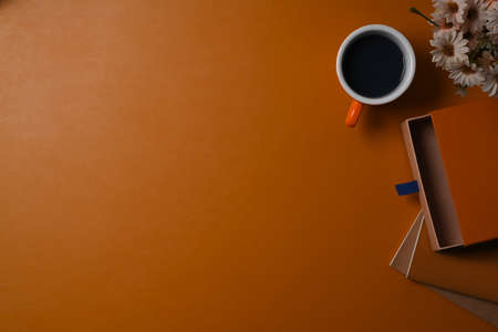 Top view cup of coffee, notebook and potted plant on brow leather.の写真素材
