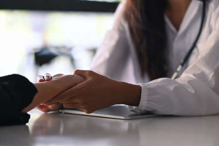 Cropped shot female doctor reassuring her male patient.の写真素材
