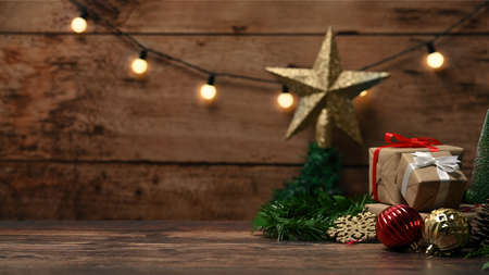 Christmas gift boxes and fir tree branches on wooden table.の写真素材