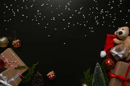 Christmas gift boxes and teddy bear decoration on dark background.の写真素材