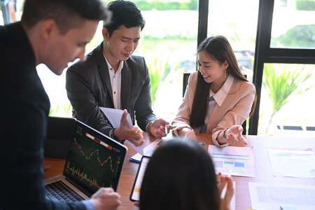 Group of successful businesspeople meeting in modern boardroom.