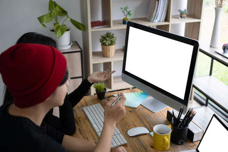 Two young creative people working on project together in office.