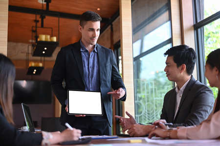 Confident businessman presentation in modern conference room for his colleagues.の写真素材