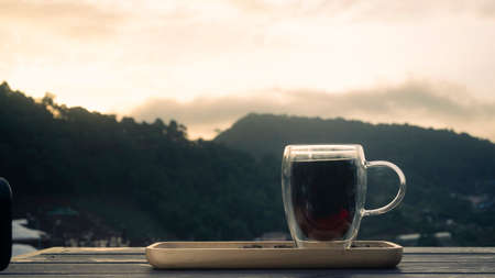 Morning cup of coffee with a beautiful mountain background.