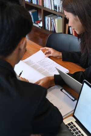 Business colleagues discussing project planning together at modern workplace.