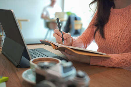 Smiling female small business entrepreneur working with laptop computer.の写真素材