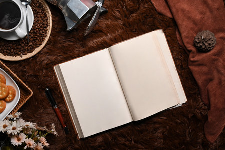 Empty notebook, coffee cup and wooden tray of cookies on carpet.の写真素材