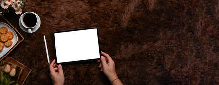 Woman using digital tablet on gray carpet.