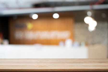 Empty wooden table with blurred living room in background. For montage your product display.の写真素材