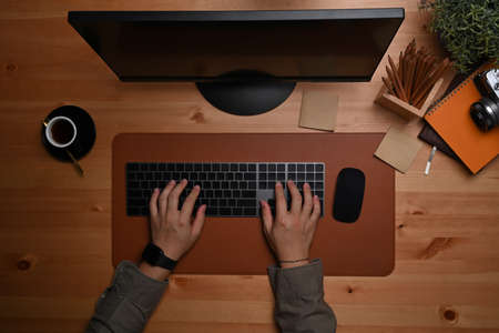 Overhead view man hands typing on keyboard.の写真素材
