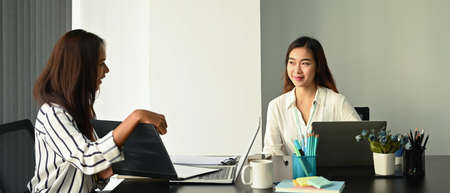 Two beautiful businesswoman working together in office.