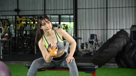 Cropped shot female offie worker using smart phone and working with computer laptop.の写真素材