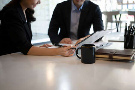 Smiling businessman holding digital tablet and shearing information to colleague.