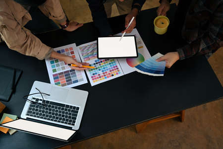 Overhead view team of graphic designer working with color chart and brainstorming for new project.の写真素材
