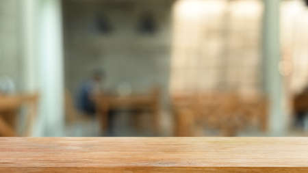 Empty wooden table or shelf on blurred background of restaurant. For present your products.