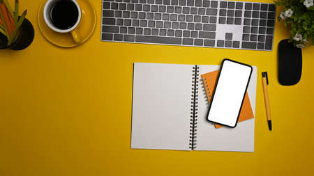 Mock up computer laptop, notebook and coffee cup on yellow background.の写真素材