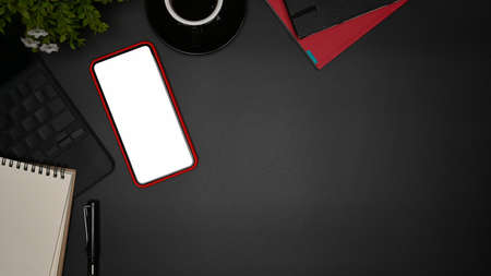 Top view smart phone, laptop computer and coffee cup on black background.の写真素材