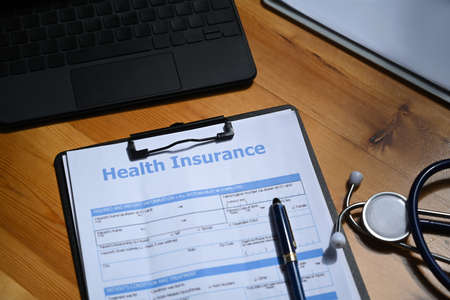 Health insurance form and stethoscope on wooden table. Health insurance concept.の写真素材