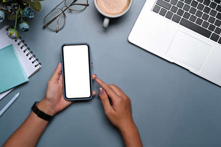 Overhead view female holding smart phone with empty screen.