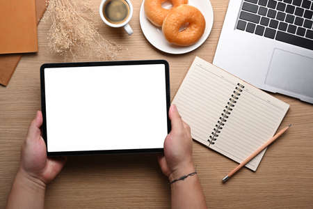 Close up view woman browsing internet with digital tablet.