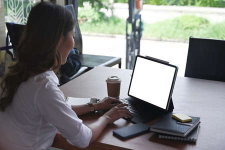 Thoughtful businesswoman sitting in office and drinking hot coffee.