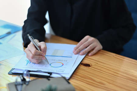 Cropped shot smiling businesswoman working in modern office.の写真素材