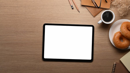 Close up view young man holding coffee cup and using digital tablet.の写真素材