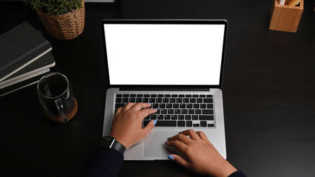 Above view young woman hands typing on laptop computer.の写真素材