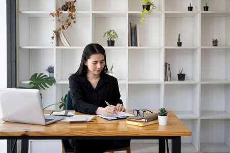 Cropped image of businesswoman using stylus pen and writing information on digital tablet.の写真素材
