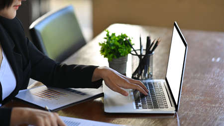 Cropped image of businesswoman using stylus pen and writing information on digital tablet.の写真素材