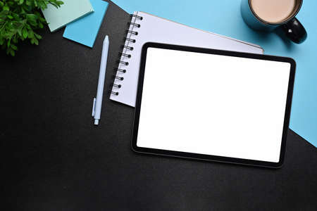 Flat lay, mock up digital tablet, notebook and coffee cup on creative workspace.