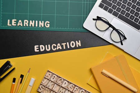 Top view computer, teddy ear and stationery on colorful background.の写真素材