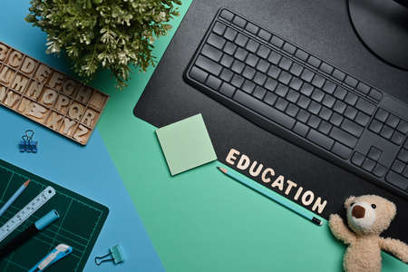 Top view computer, teddy ear and stationery on colorful background.の写真素材