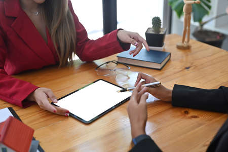 Two business partner discussing their project together in modern workplace.