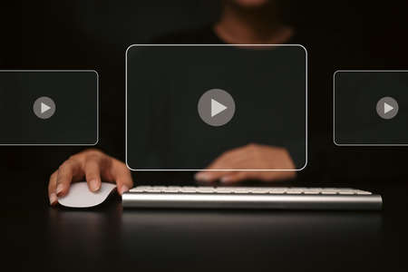 Woman using wireless mouse and keyboard for watching video on the internet with virtual screen.