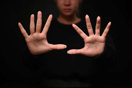 Assertive woman making stop gesture. Expressing security, defense, restriction and negative...