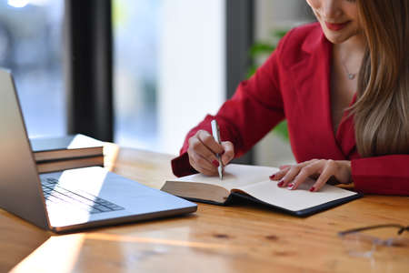 Portrait of real estate agent preparing contract document and working with laptop in office.の写真素材